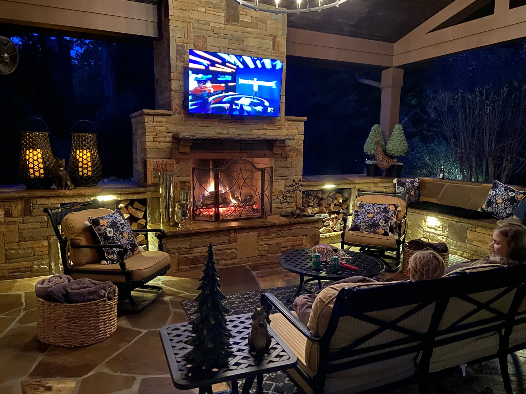 Custom United Poolscapes pavilion with a stone fireplace and covered seating